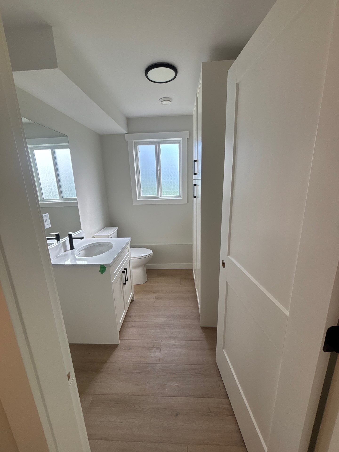 Matching shaker bathroom vanities with quartz countertop — Langley, BC