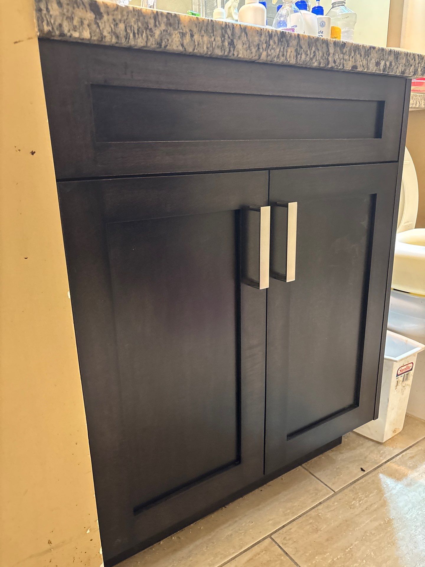 Dark espresso shaker cabinet door close-up showing joinery and chrome bar pull detail — Pitt Meadows, BC